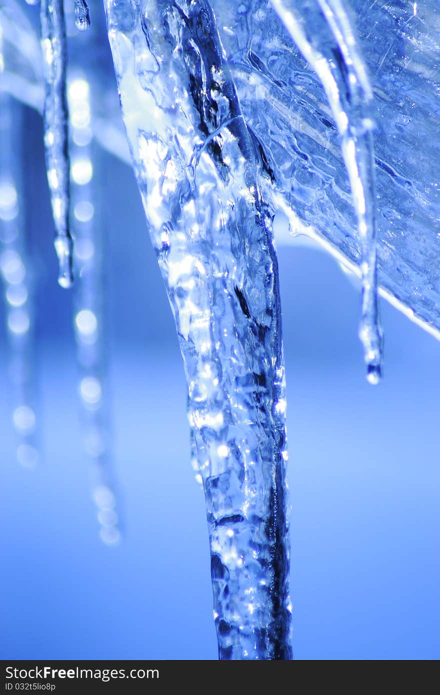 Icicle coming down from our roof. The blurred background is the sky. December 2010. Icicle coming down from our roof. The blurred background is the sky. December 2010