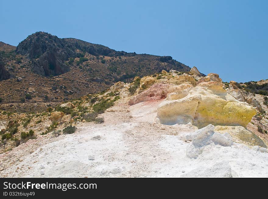 View from volcano on island of Nisyros showing coloured minerals in rock. View from volcano on island of Nisyros showing coloured minerals in rock.