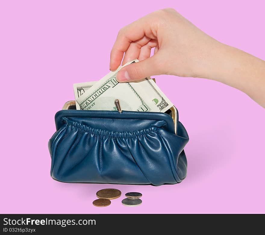 Female hand puts money into the wallet