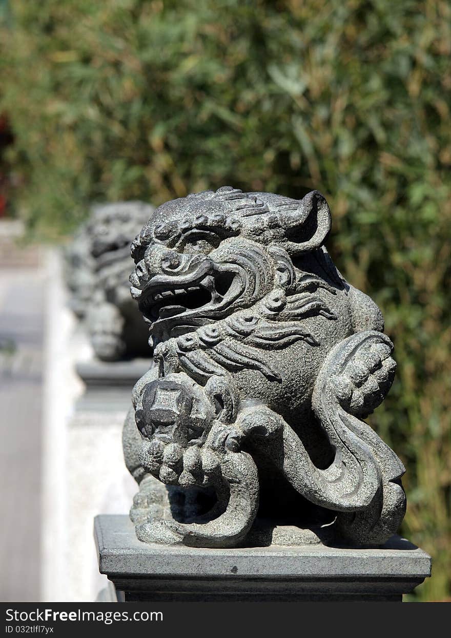 Row of stone Chinese lion statue