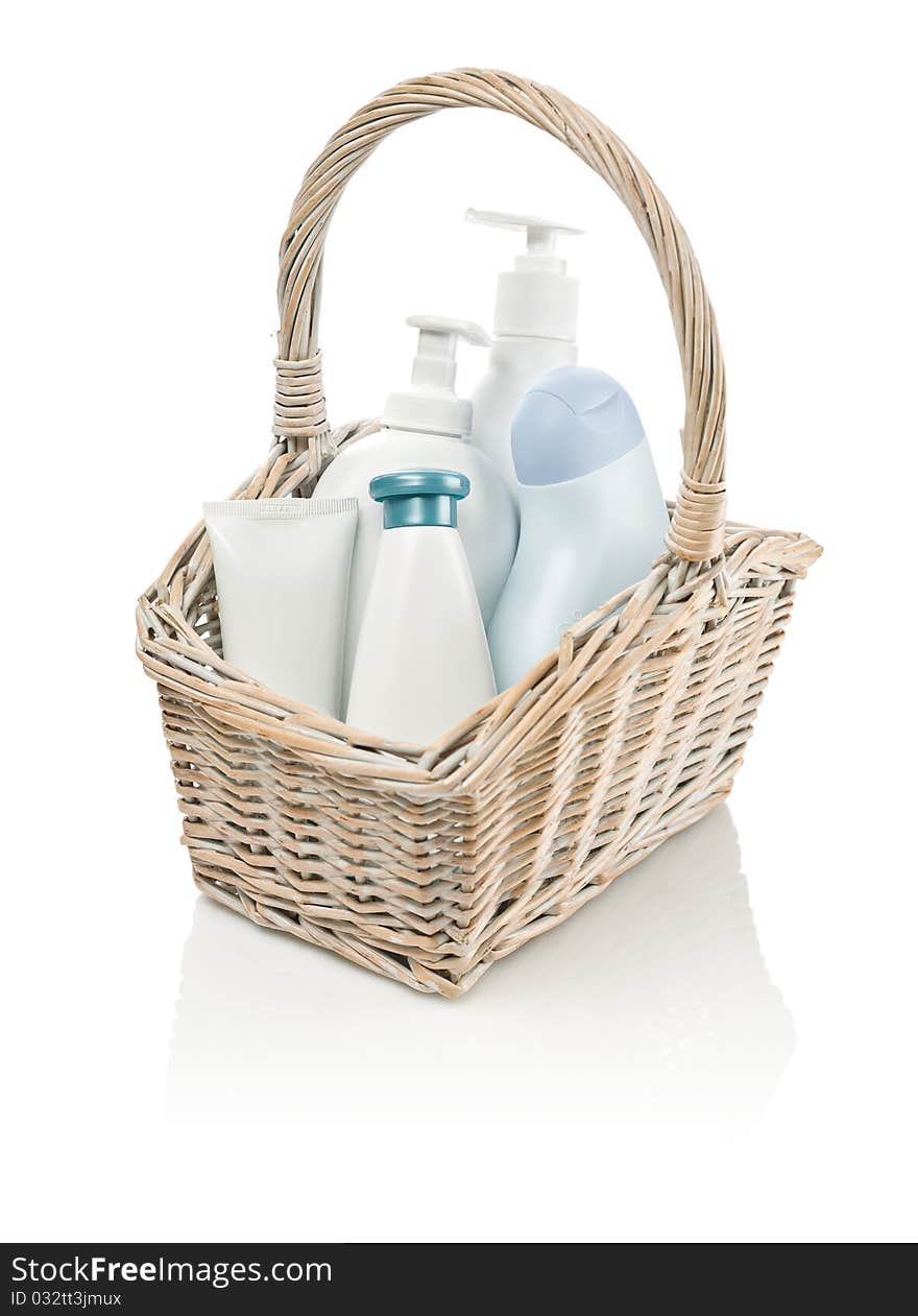 Toiletries in basket isolated on white background