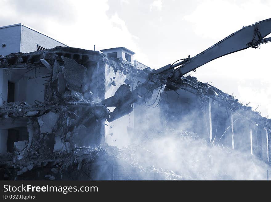 Demolition excavator at work on an old building in Stuttgart/Germany. Demolition excavator at work on an old building in Stuttgart/Germany