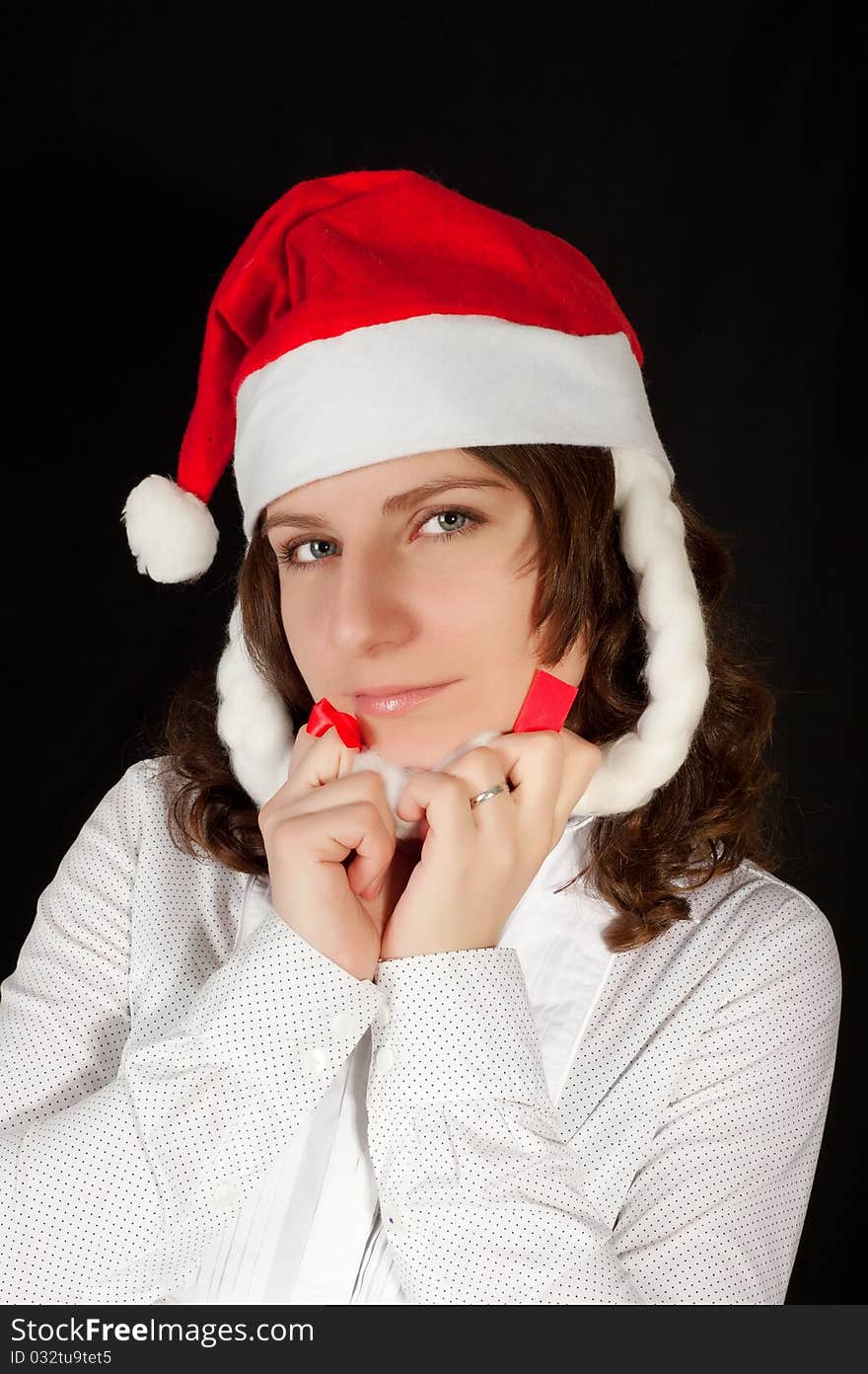 Beautiful young woman in red wearing santa hat. Isolated on white background.