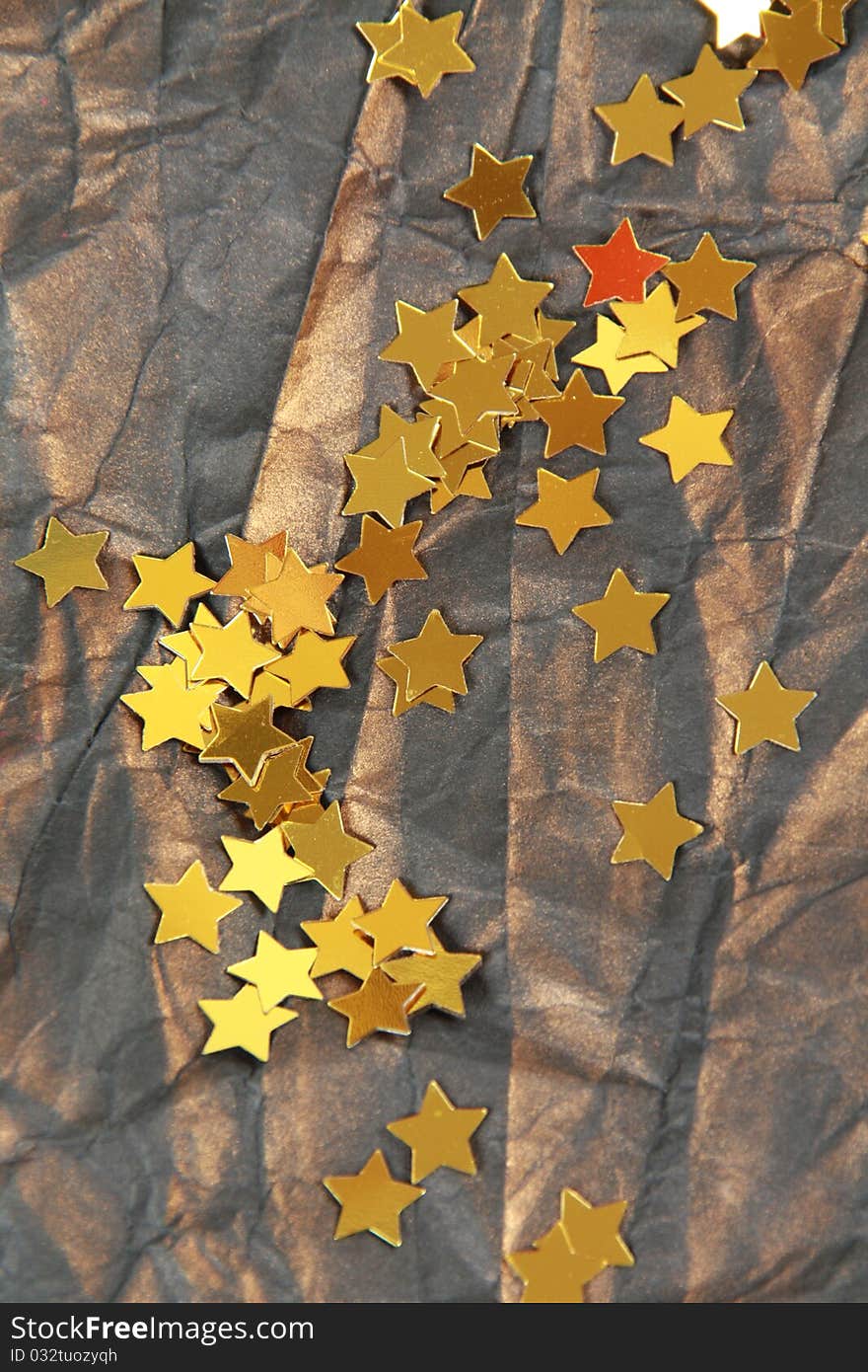 Golden stars on brown crumpled paper