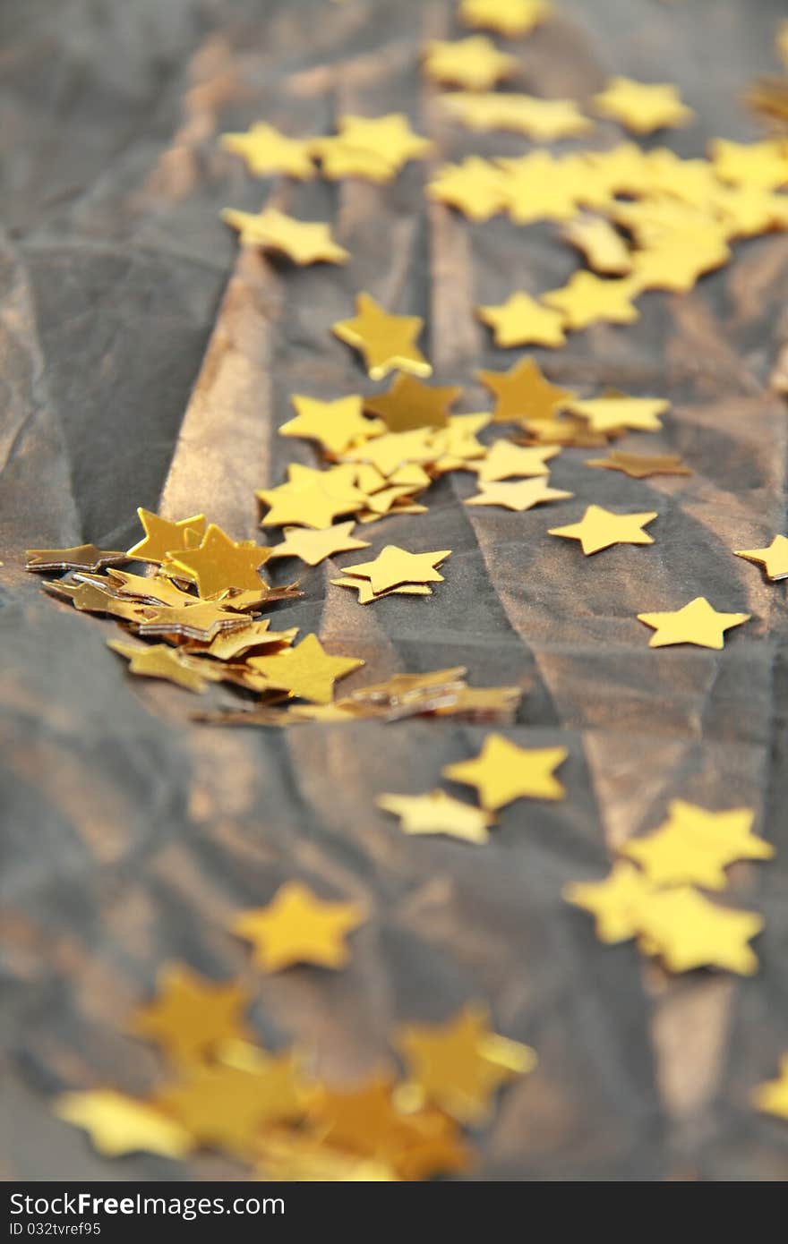 Golden stars on brown crumpled paper