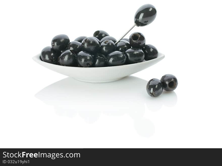 Black olives on a plate with skewer