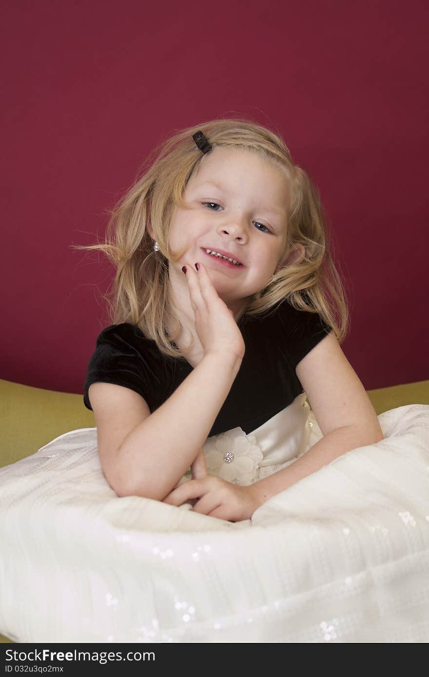 Beautiful young girl posing for the camera on couch. Beautiful young girl posing for the camera on couch