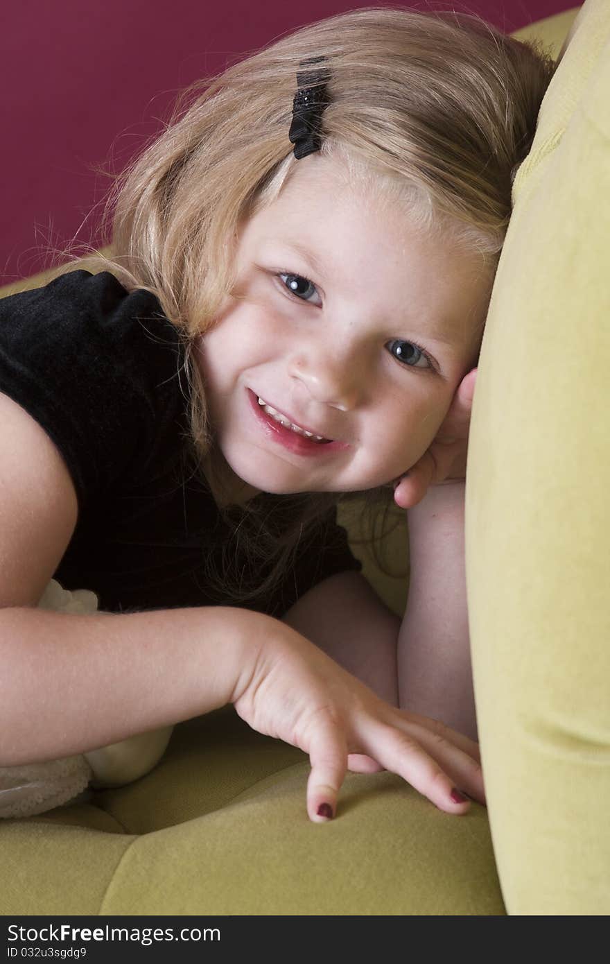 Big smile on beautiful young girl laying on couch. Big smile on beautiful young girl laying on couch