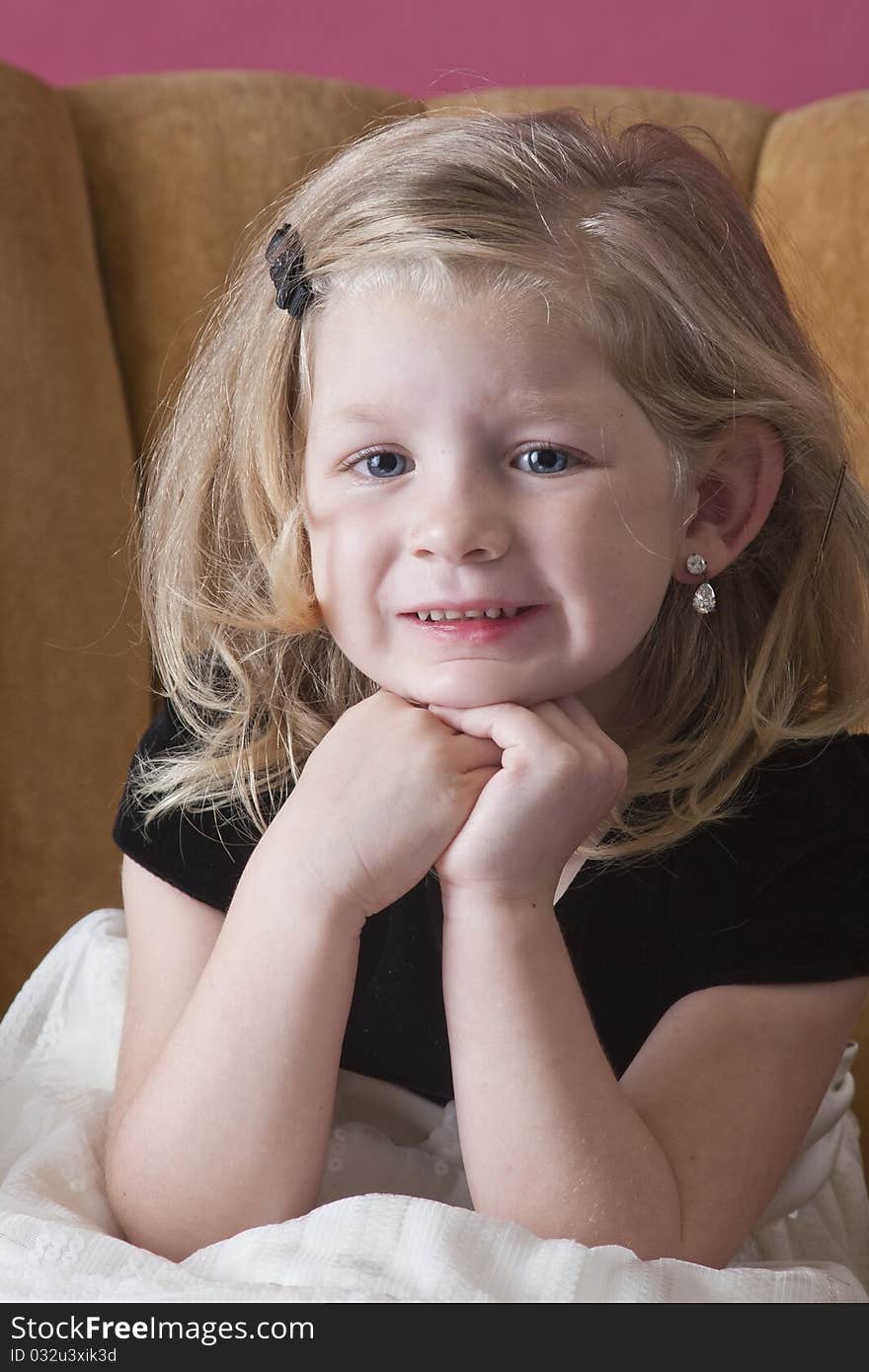 Big smile on beautiful young girl sitting on chair. Big smile on beautiful young girl sitting on chair