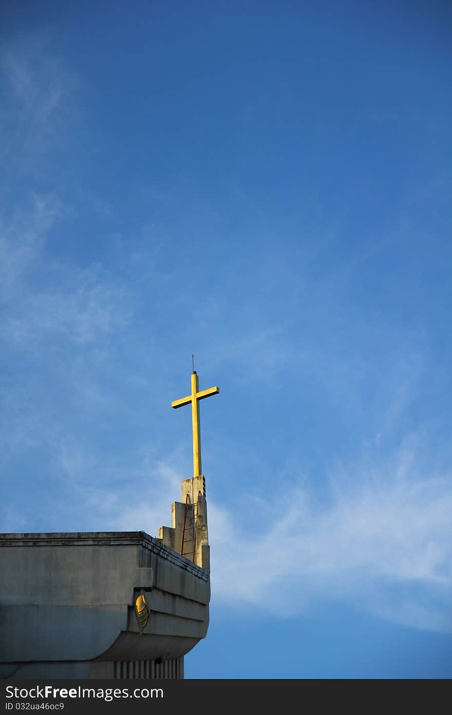 Church and cross in blue sky