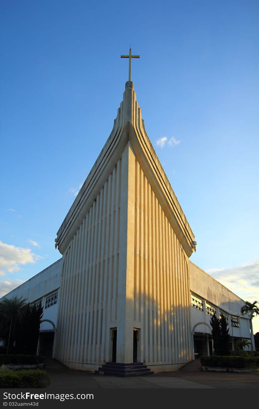 Church and cross in blue sky