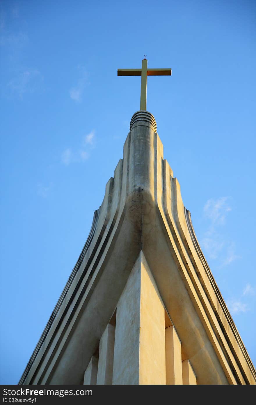 Church and cross in blue sky