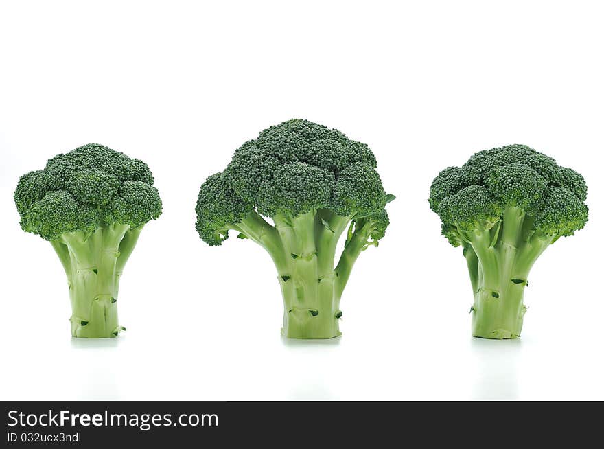 Three broccolis on a white background