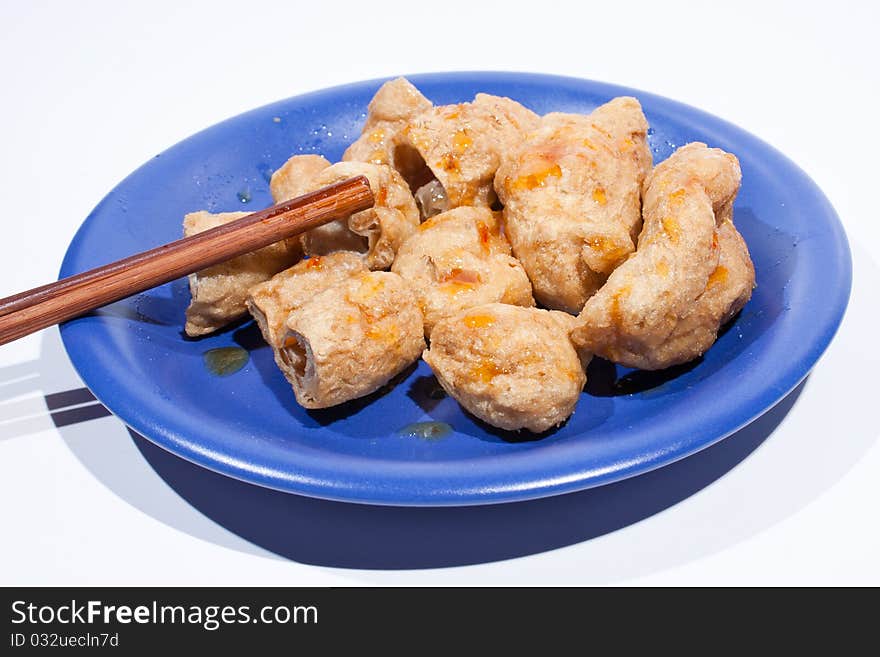 Fried fish balls with chopsticks.