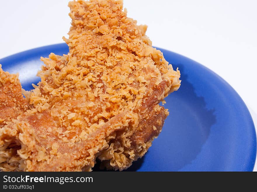 Fried chicken dish dark blue. Placed on a white background, then shoot.