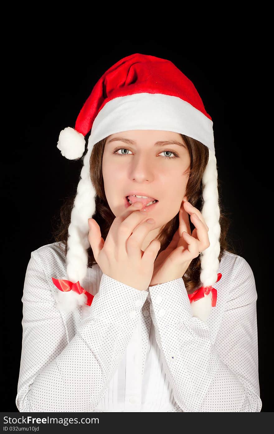 Beautiful young woman in red wearing santa hat. Isolated on white background.