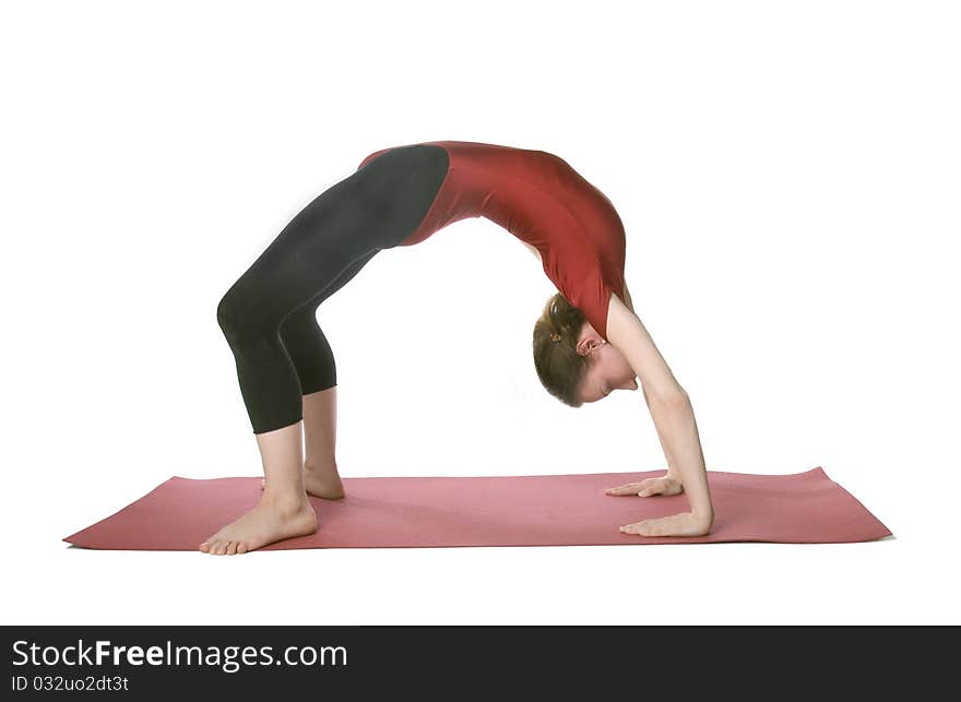 Woman doing a crab posture on a mat over white background. Woman doing a crab posture on a mat over white background