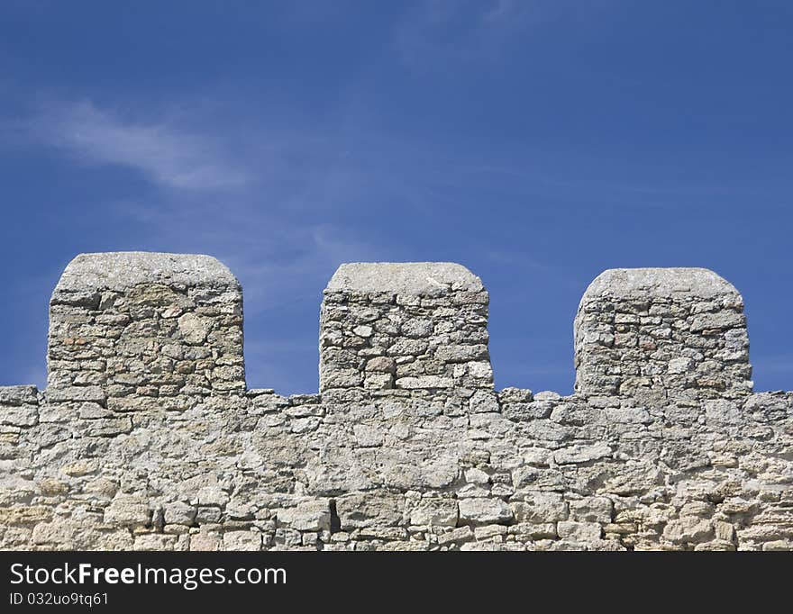 Merlons of an old fortress wall in a sunny day