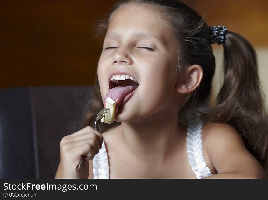 Smiling girl with cheese on she fork