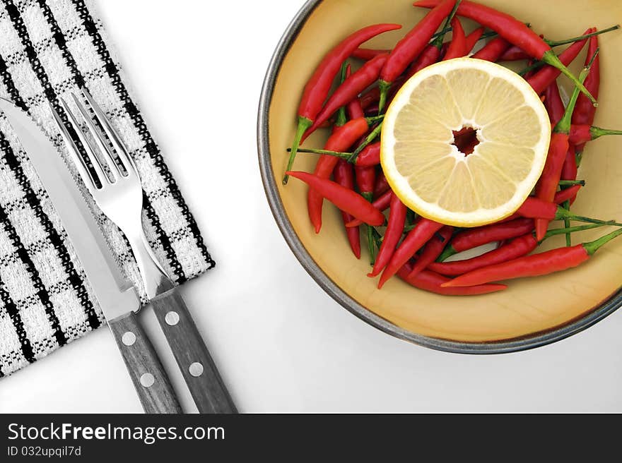 Composition of lemon, chilli, napkin and cutlery in black and white and colour version. Composition of lemon, chilli, napkin and cutlery in black and white and colour version