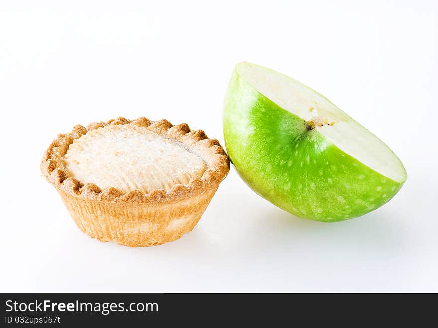 Freshly made apple pie and half of apple over white background