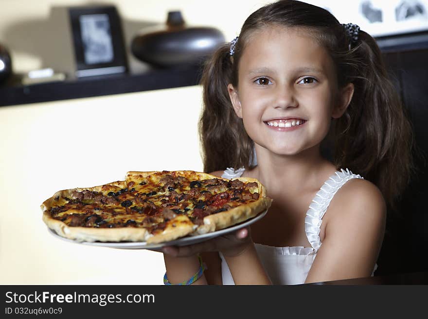 Smiling girl with big pizza