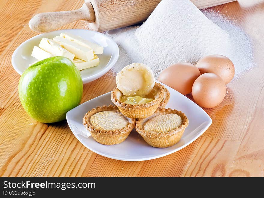 Freshly made apple pies on the table with one open. Freshly made apple pies on the table with one open