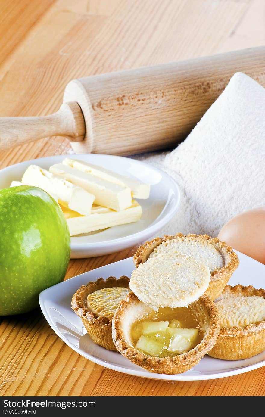 Freshly made apple pies on the table with one open. Freshly made apple pies on the table with one open