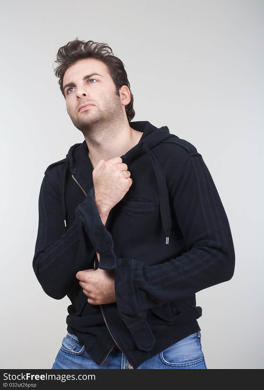 Portrait of man in black sweater looking up - isolated on gray. Portrait of man in black sweater looking up - isolated on gray