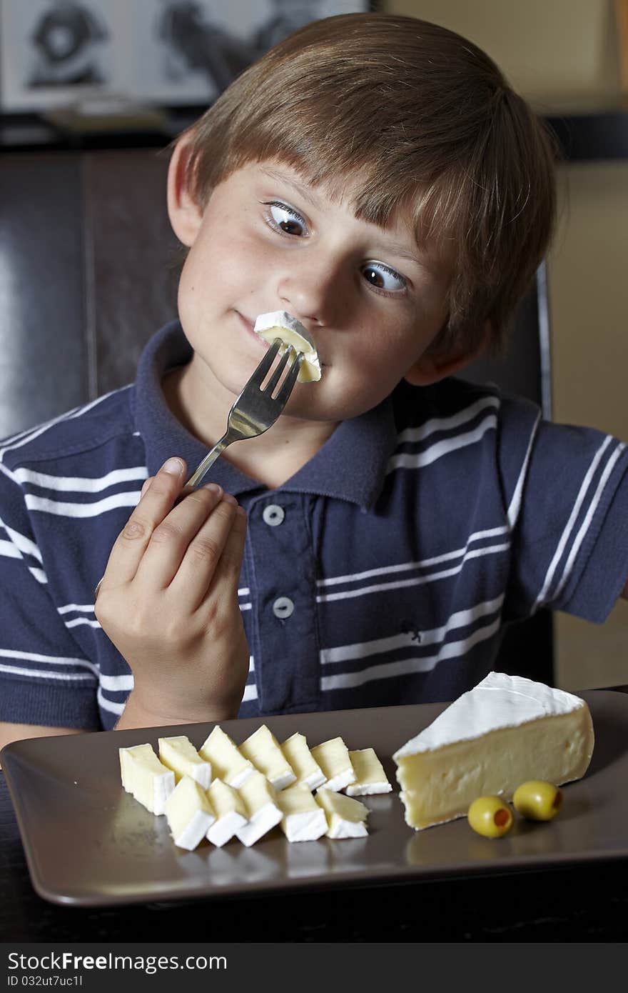 Smiling boy with cheese on here fork