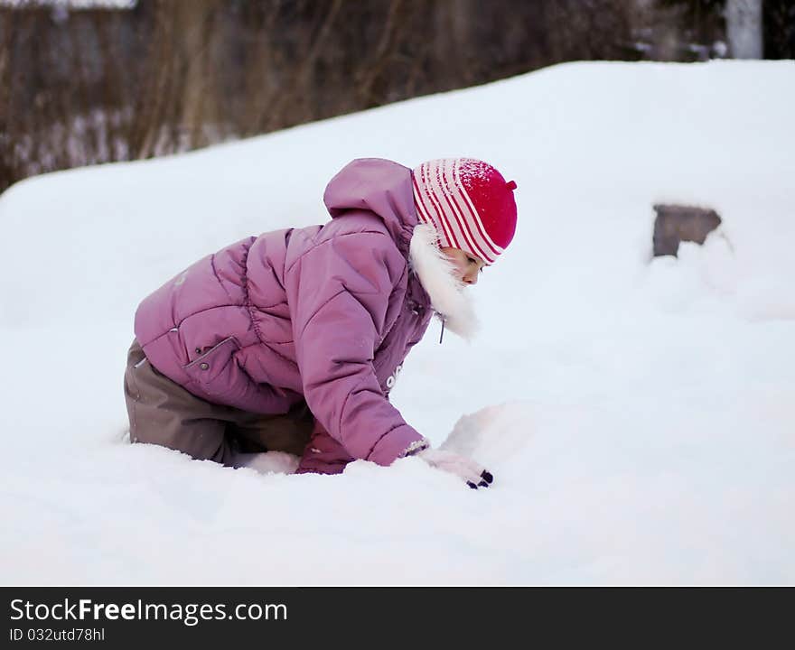 A little baby walking in a snow. A little baby walking in a snow