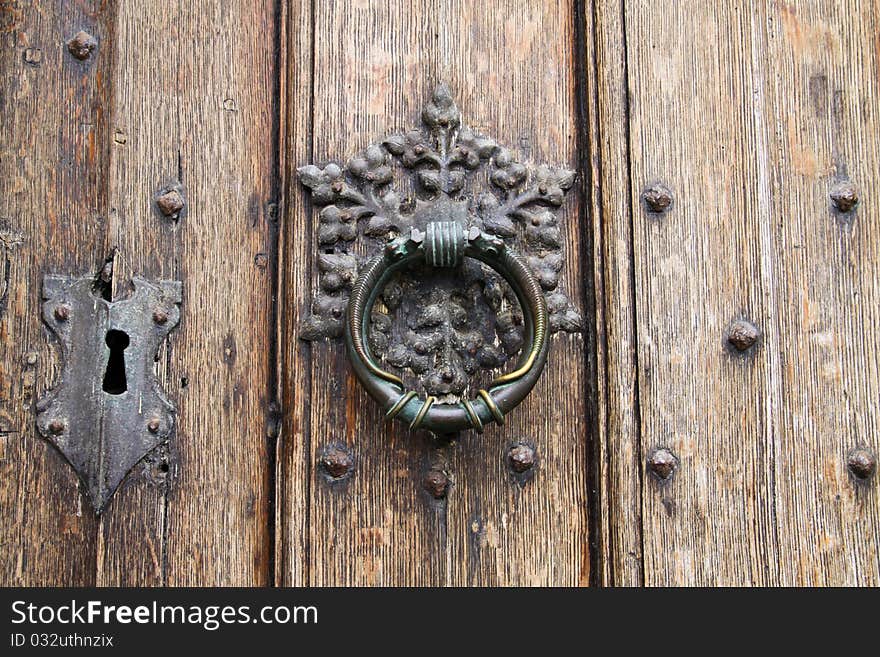 Antique Door Knocker On Wooden Door