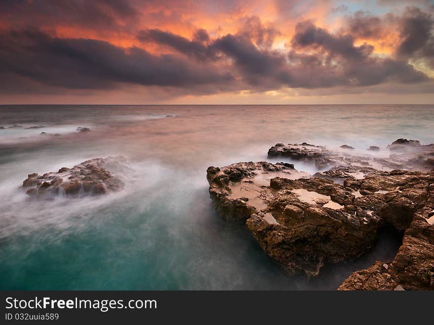 Beautiful seascape. Sea and rock at the sunset. Nature composition.