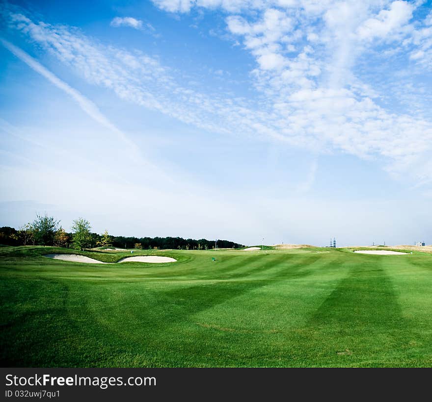 Golf green field and  blue sky with white clouds. Golf green field and  blue sky with white clouds