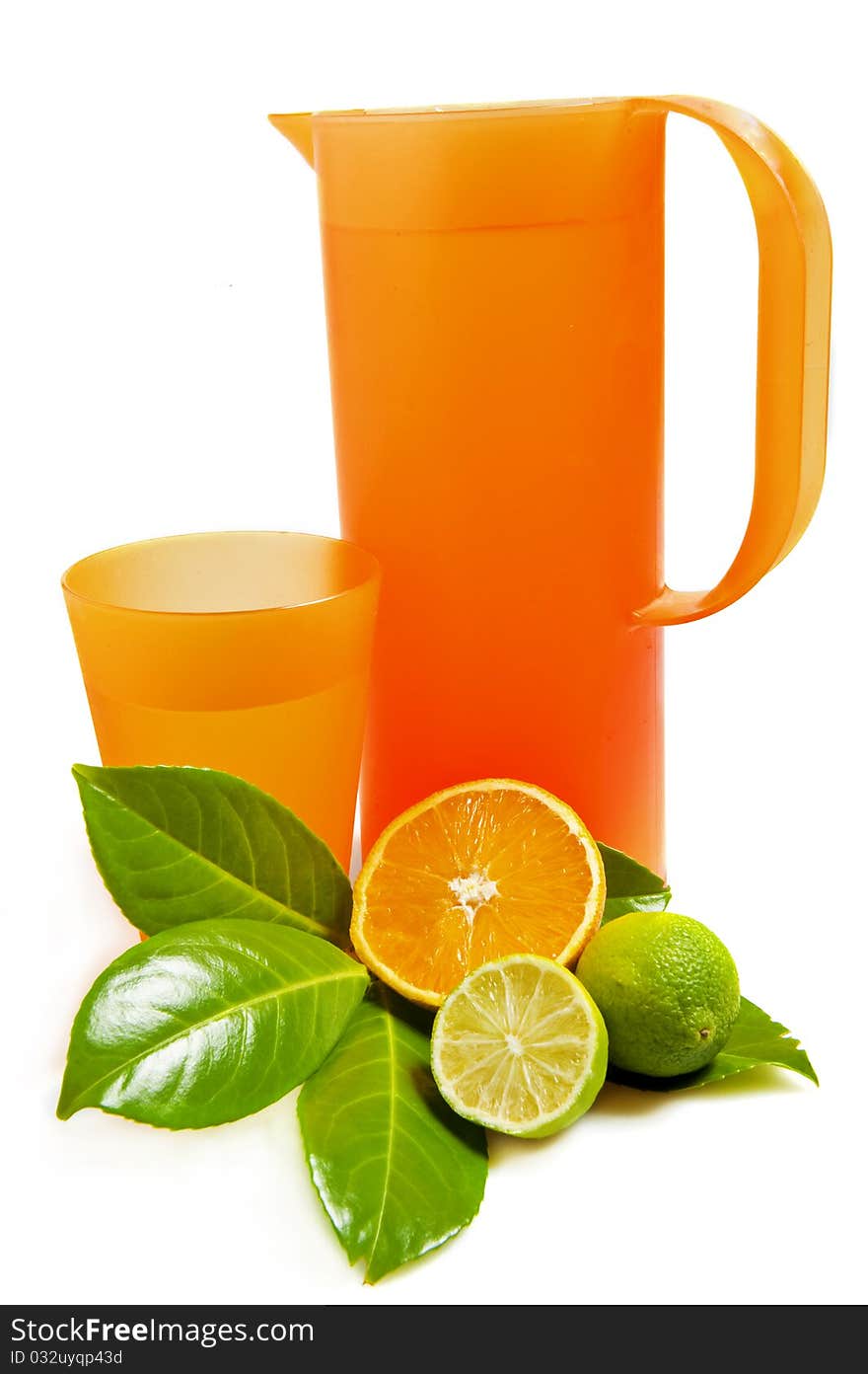 Pitcher and glass with Lime and orange on white background. Pitcher and glass with Lime and orange on white background