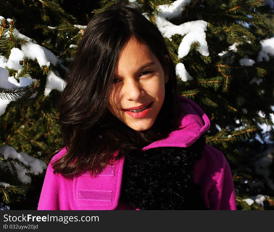 A young female hiker walking through a winter forest