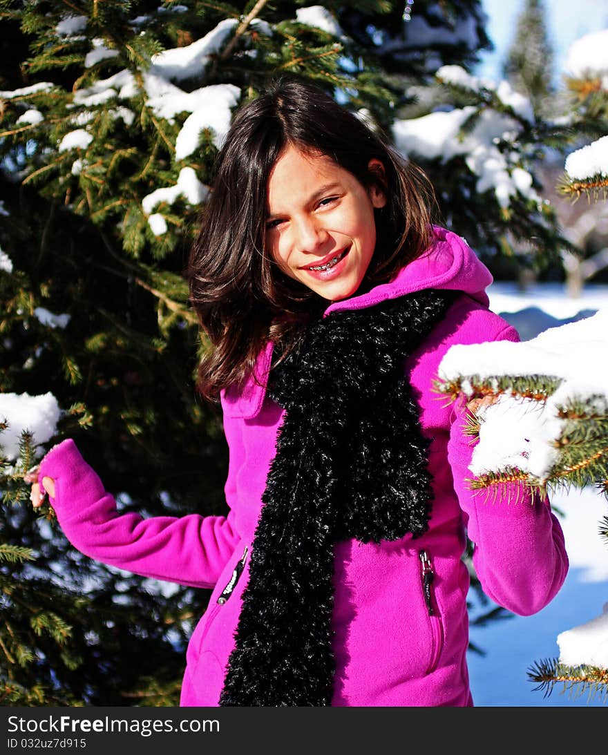 A young female hiker walking through a winter forest