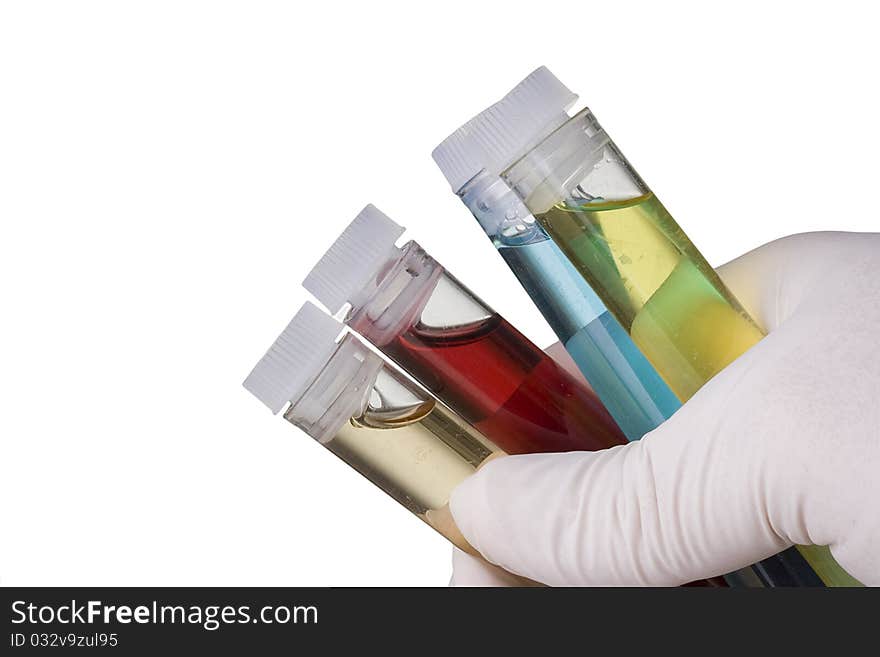 Hand in a glove holding test tubes. Hand in a glove holding test tubes.