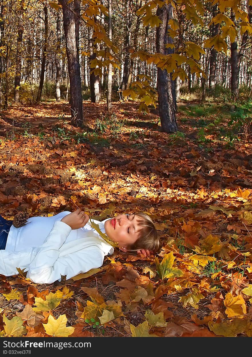 Beautiful Blonde With Leaf In The Autumn Forest