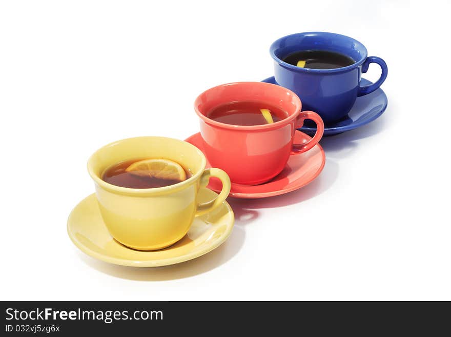 Three color cups of black tea with lemon isolated on white background with clipping path. Three color cups of black tea with lemon isolated on white background with clipping path