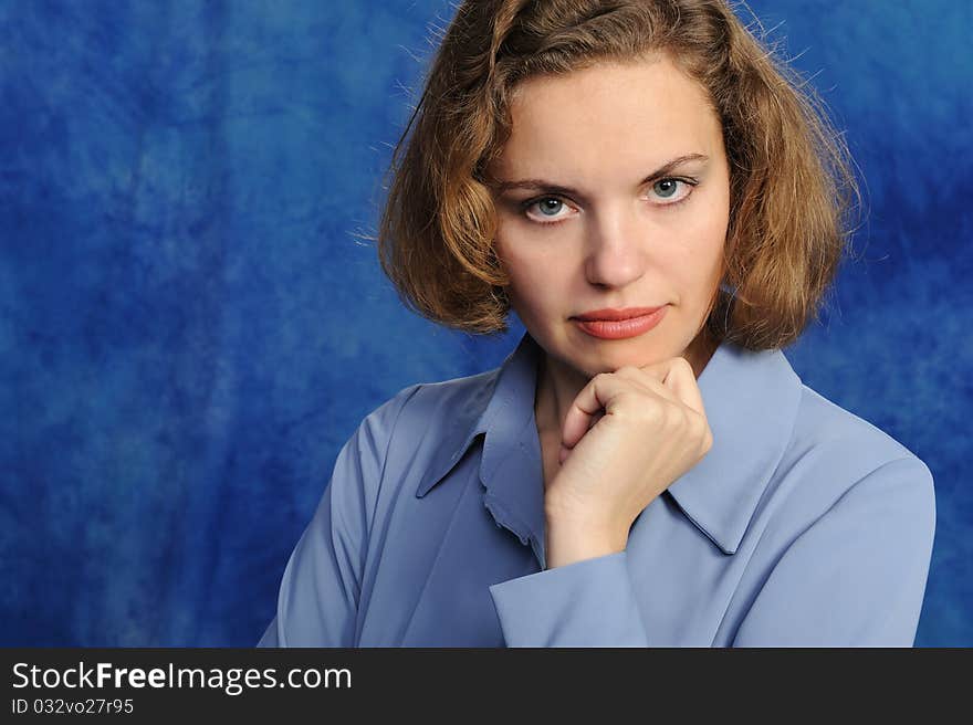 Portrait of the attractive woman on a blue background