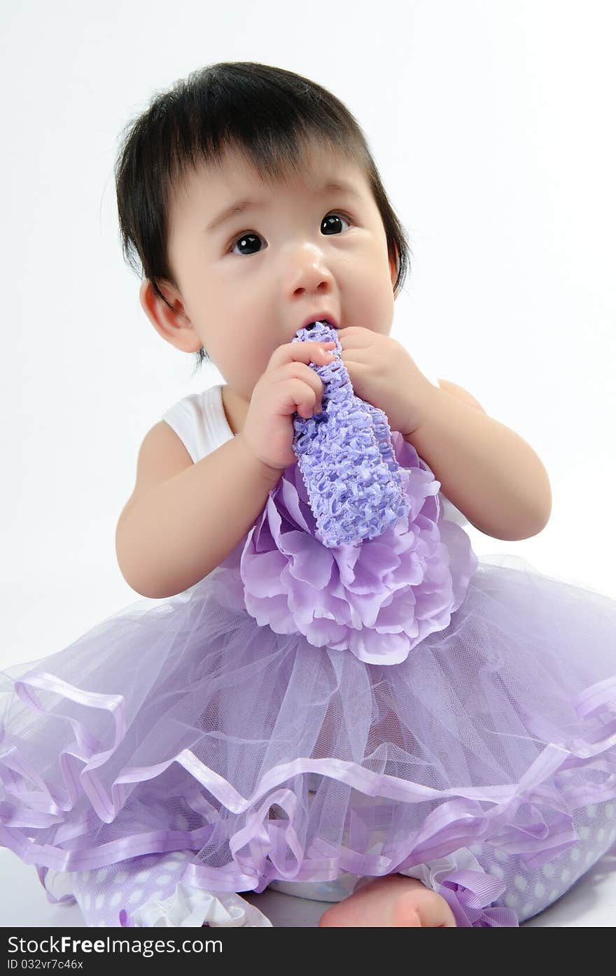 Kid wear in purple dress on floor. Kid wear in purple dress on floor