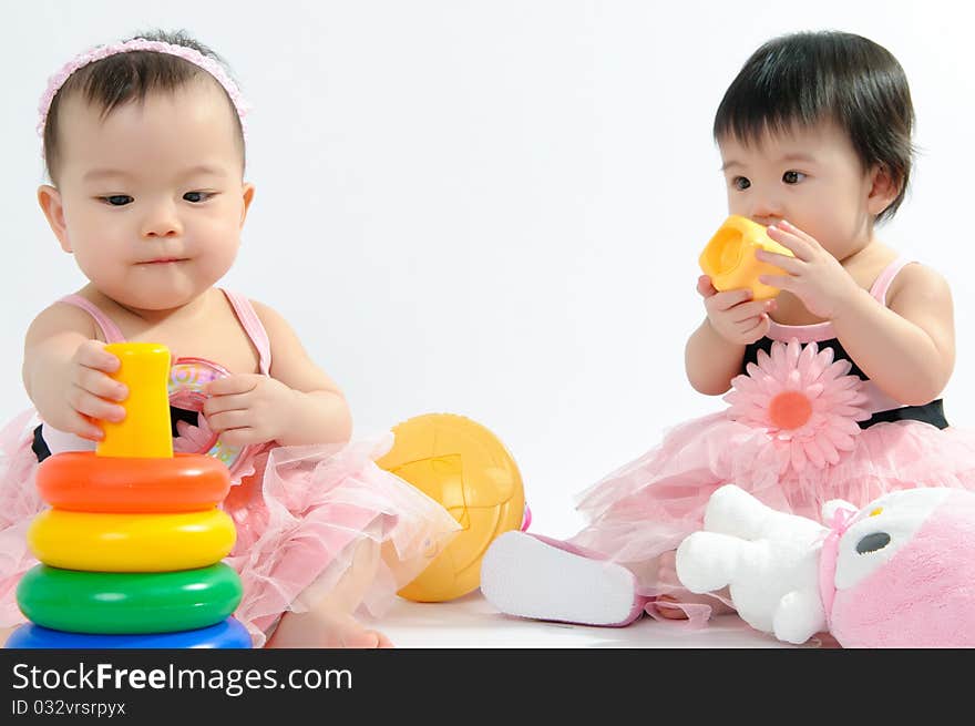 Kid in pink dress playing toy