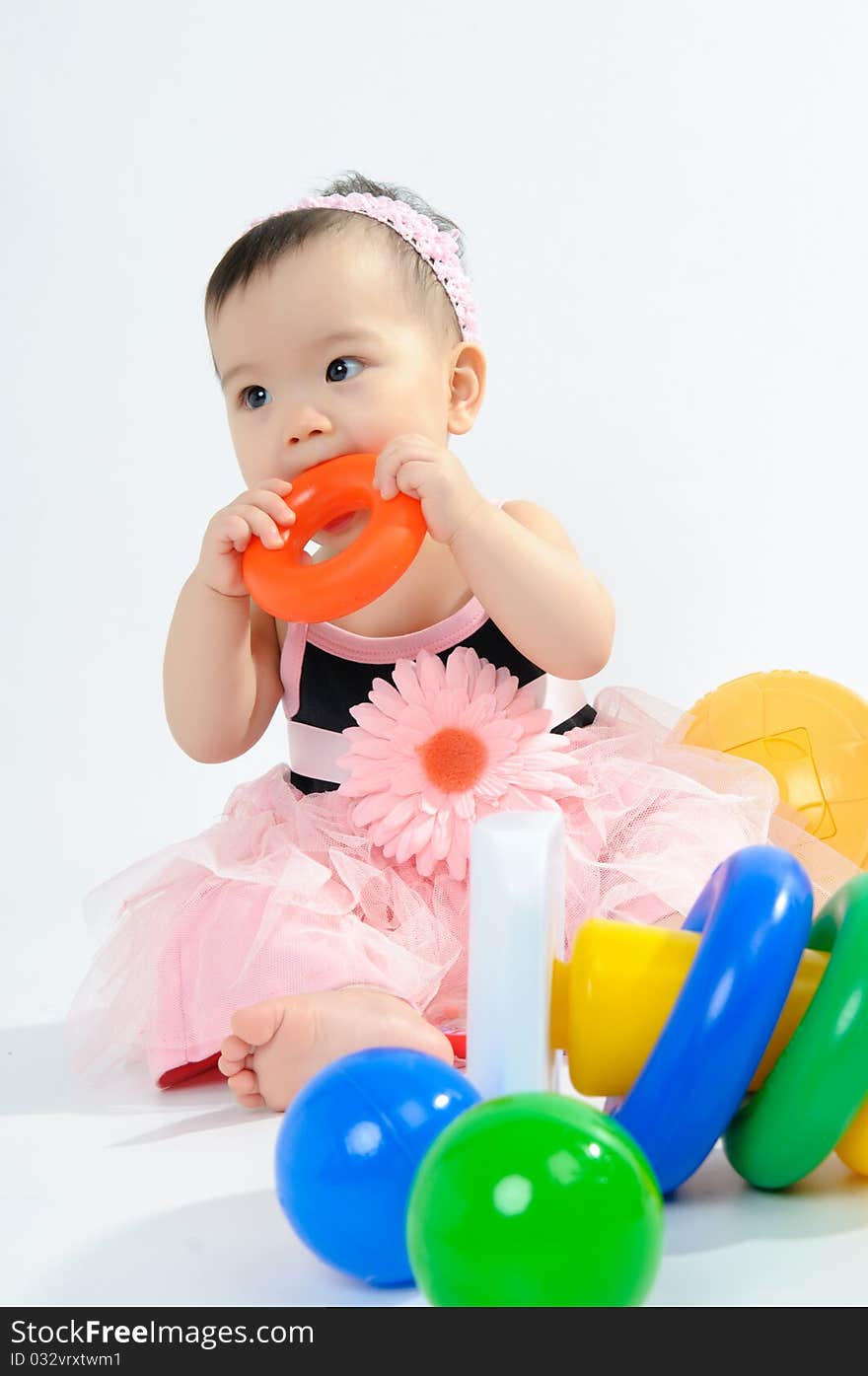 Kid In Pink Dress Playing Toy