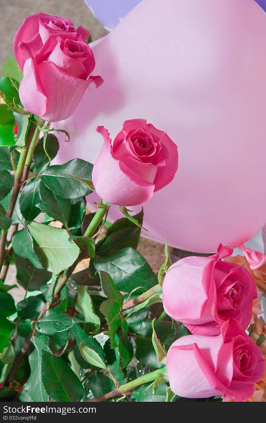 Bouquet of pink roses against an air rubber sphere. Bouquet of pink roses against an air rubber sphere.