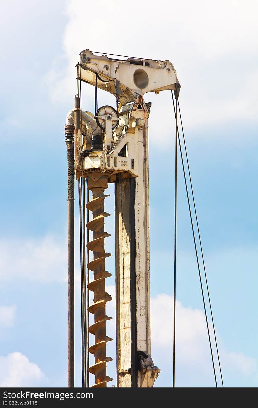 Auger Part Over Blue Sky With Clouds