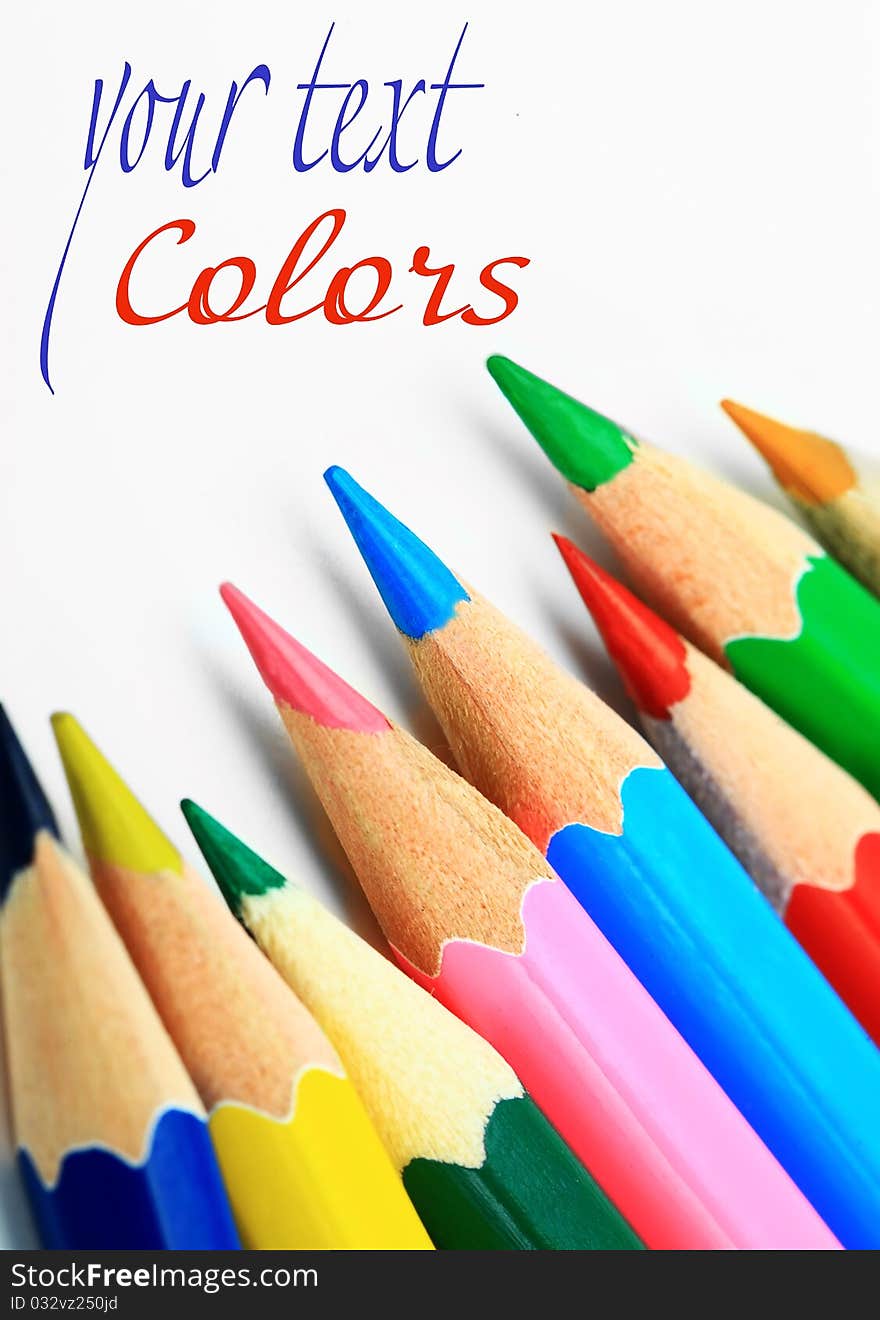 Colored pencils on white background. Colored pencils on white background