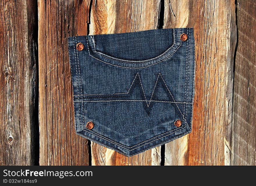 Jeans pocket on a wooden texture