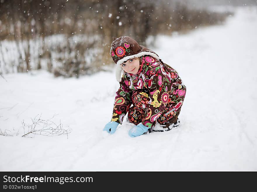 Small girl in strong snow fall