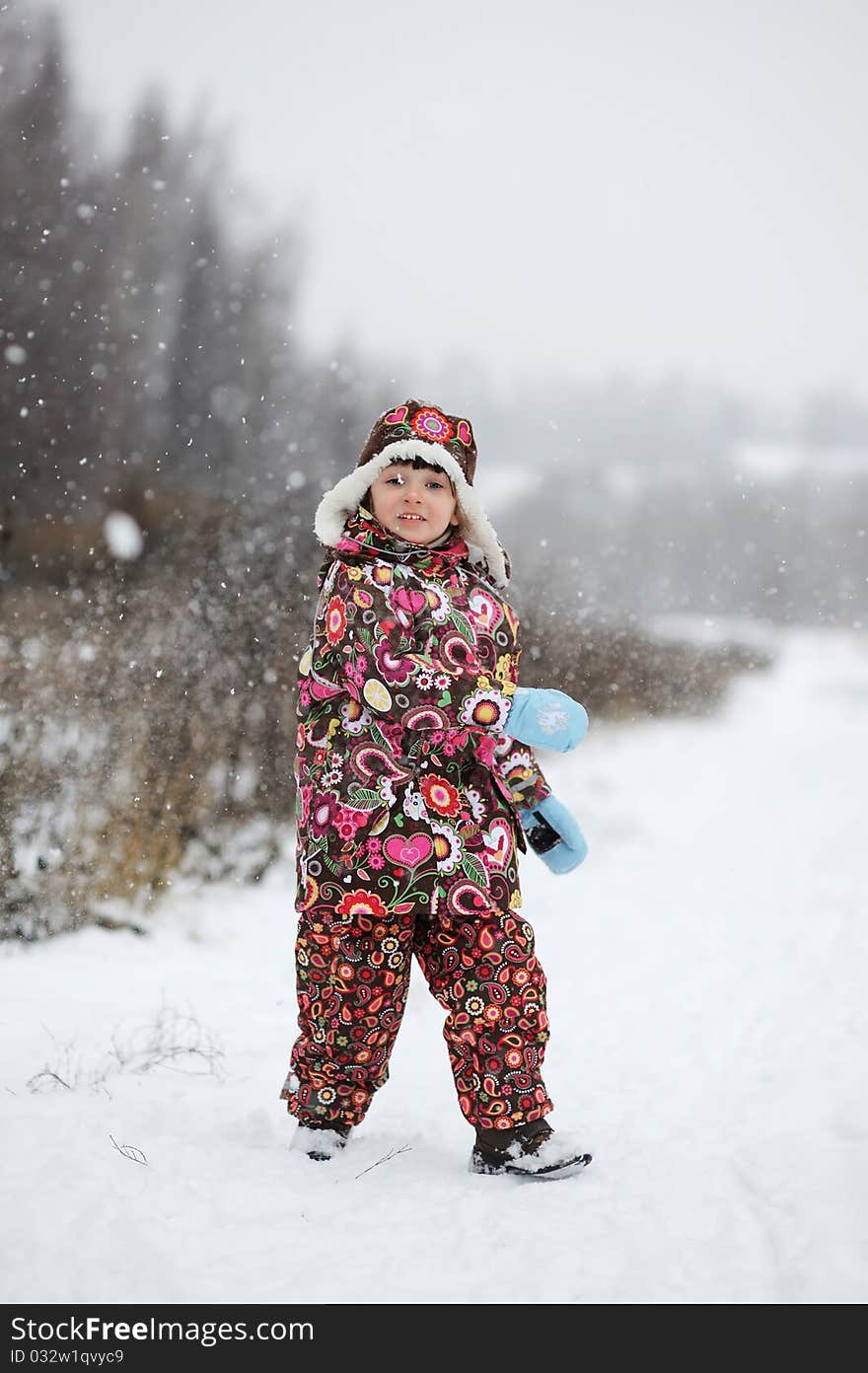 Small girl in strong snow fall